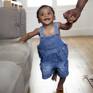 Photo of boy walking by couch